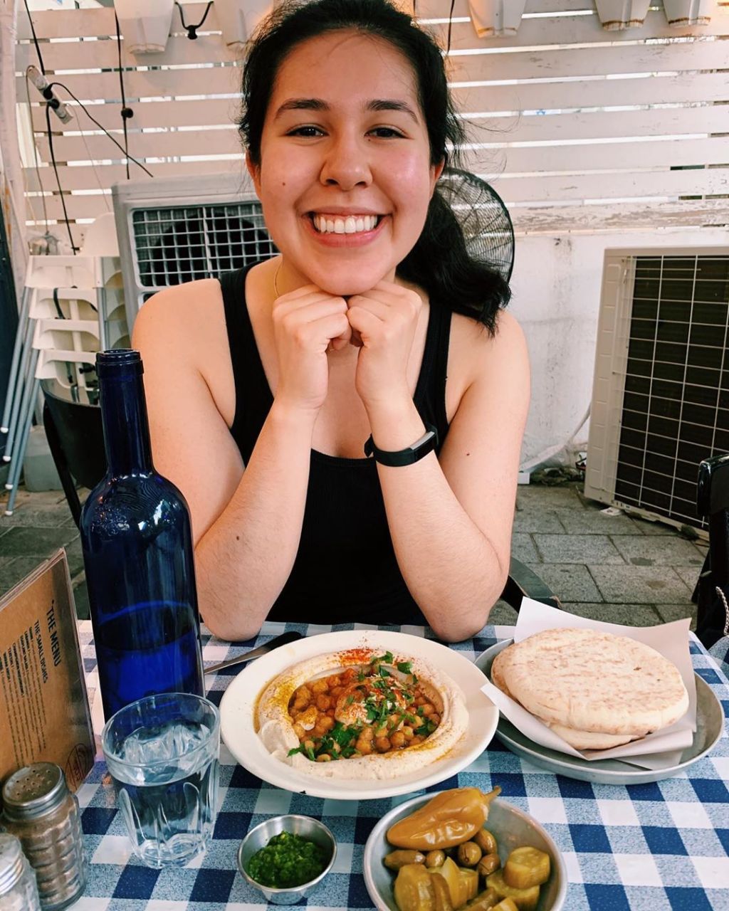 An Jimenez posing with a plate of Israeli food.