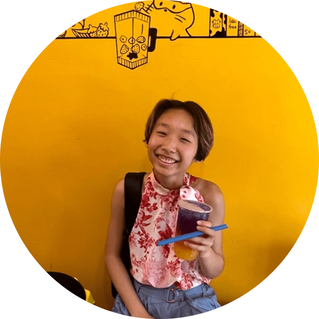 Tian Lin smiling at the camera while holding a cup of boba tea